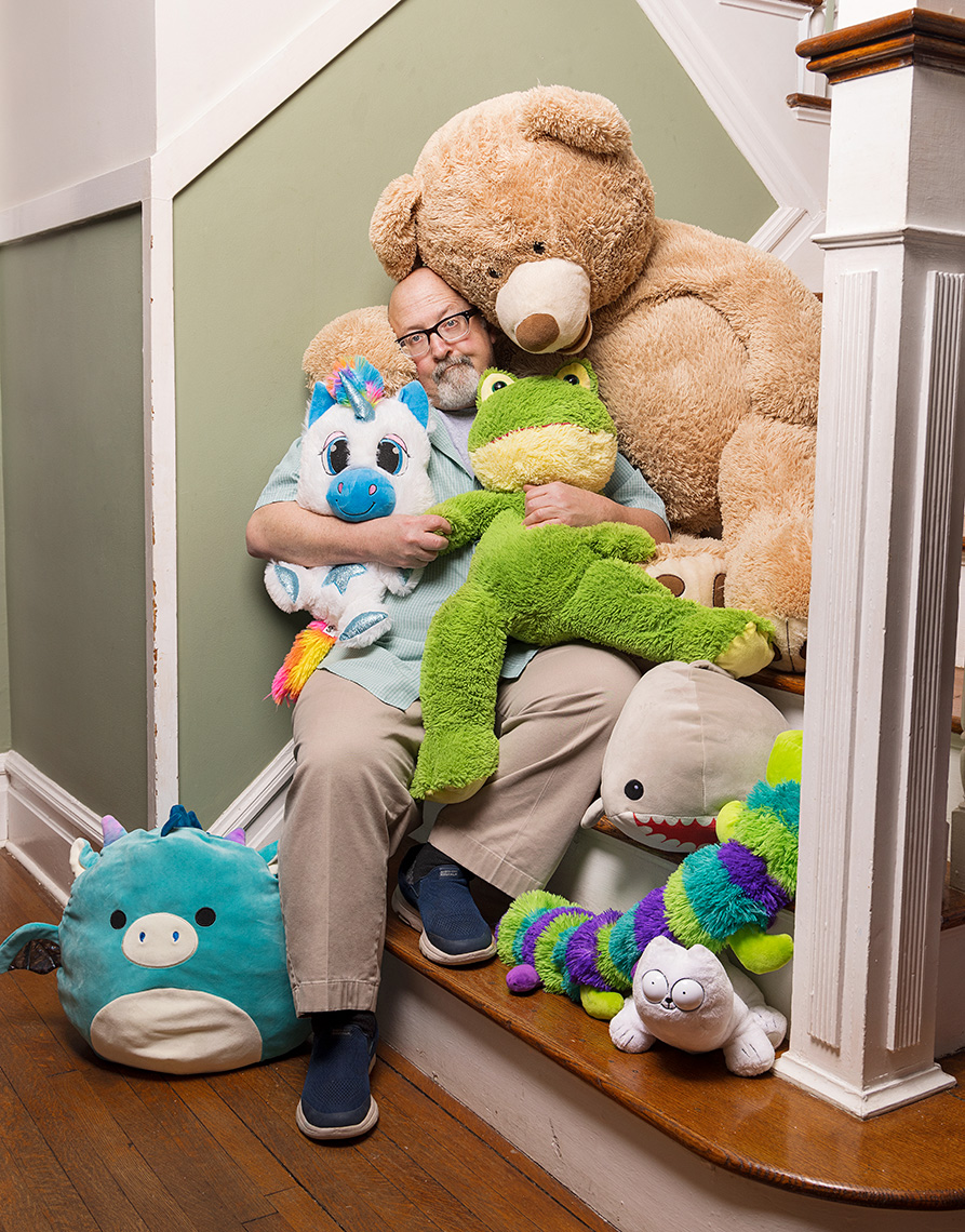 Writer Gary Rudoren at home, covered in stuffed animals.