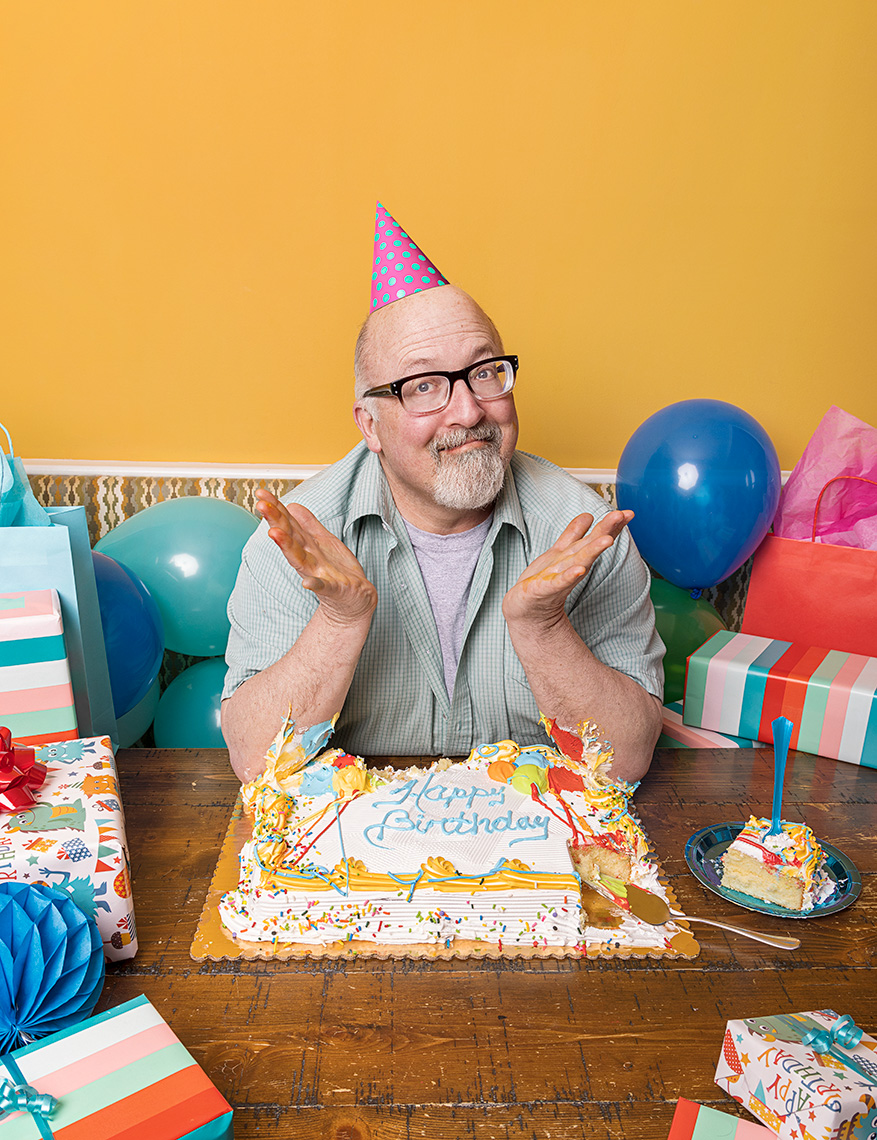 Writer Gary Rudoren with his elbows in Birthday cake.